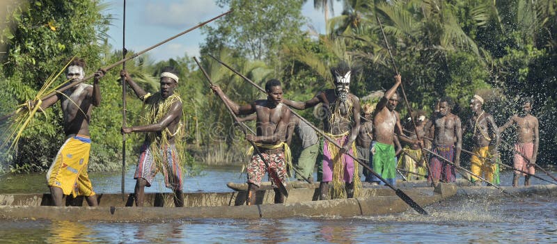INDONESIA, IRIAN JAYA, ASMAT PROVINCE, JOW VILLAGE - JUNE 23: Canoe war ceremony of Asmat people. Headhunters of a tribe of Asmat . New Guinea Island, Indonesia. June 23, 2016. INDONESIA, IRIAN JAYA, ASMAT PROVINCE, JOW VILLAGE - JUNE 23: Canoe war ceremony of Asmat people. Headhunters of a tribe of Asmat . New Guinea Island, Indonesia. June 23, 2016