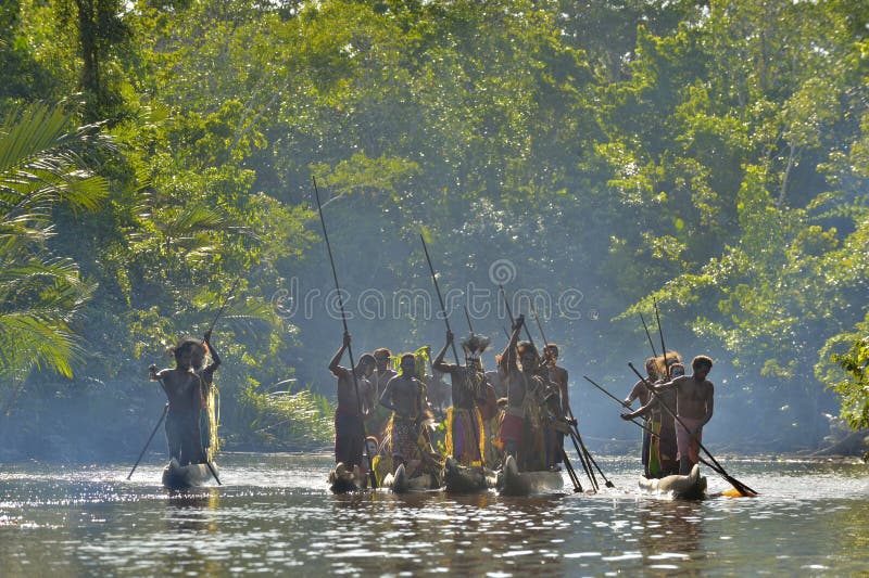 INDONESIA, IRIAN JAYA, ASMAT PROVINCE, JOW VILLAGE - JUNE 23: Canoe war ceremony of Asmat people. Headhunters of a tribe of Asmat . New Guinea Island, Indonesia. June 23, 2016. INDONESIA, IRIAN JAYA, ASMAT PROVINCE, JOW VILLAGE - JUNE 23: Canoe war ceremony of Asmat people. Headhunters of a tribe of Asmat . New Guinea Island, Indonesia. June 23, 2016