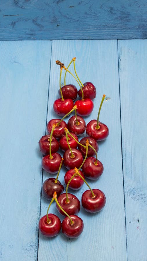Download Cerises Sur Un Conseil Bleu Photo stock - Image du avoine, nourriture: 56482474