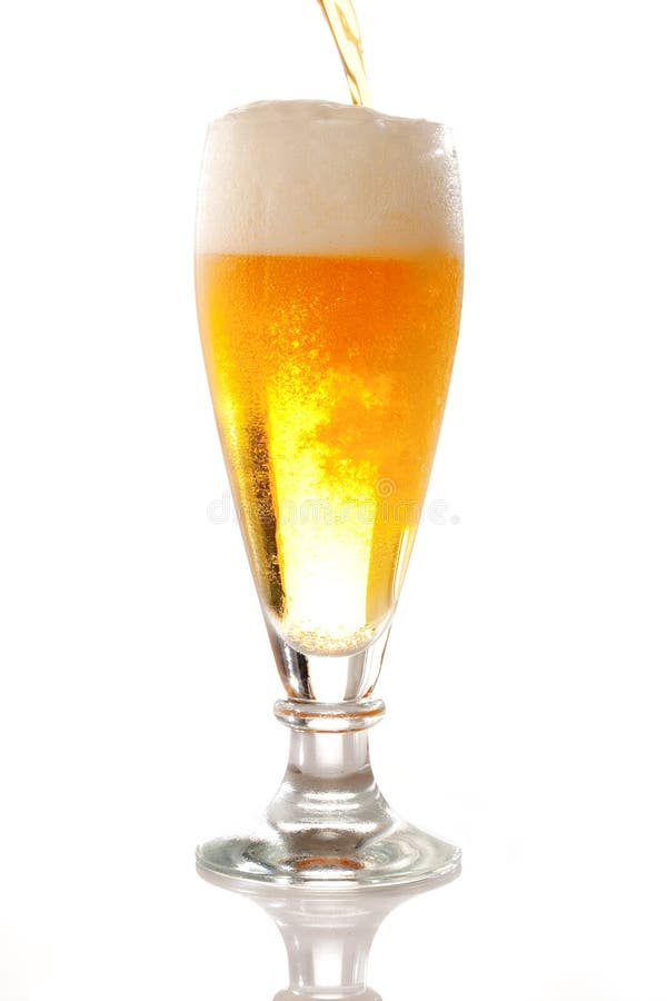 Pouring fresh brewed beer into a glass. Pouring fresh brewed beer into a glass