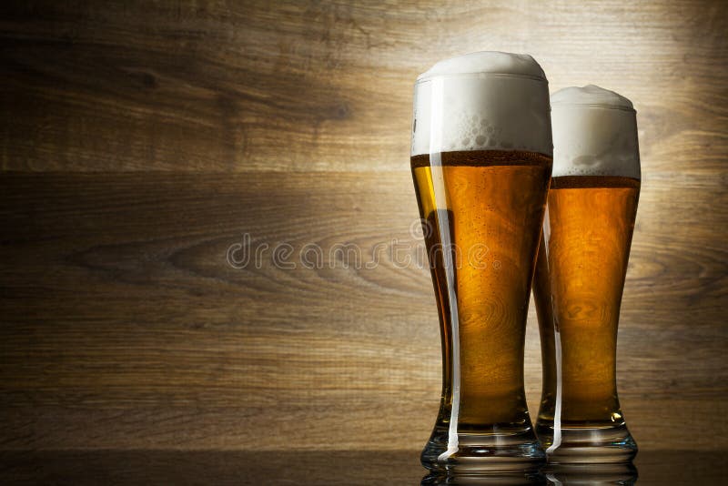 Two glass beer on wood background with copyspace. Two glass beer on wood background with copyspace