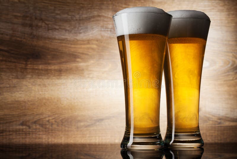 Two glass beer on wood background with copyspace. Two glass beer on wood background with copyspace