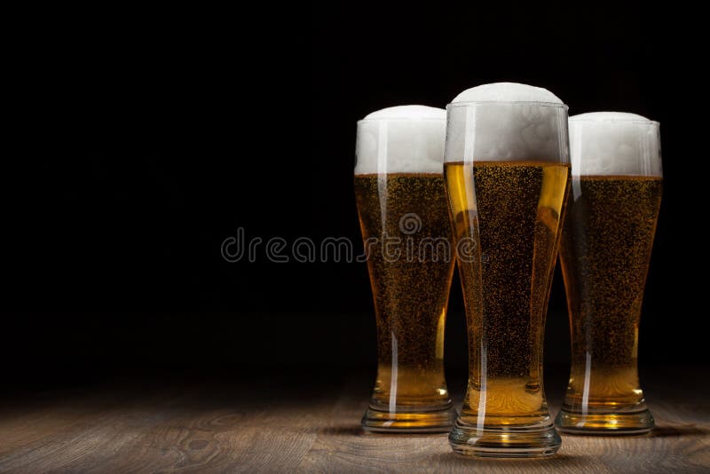 Three glass beer on wooden table with copyspace. Three glass beer on wooden table with copyspace