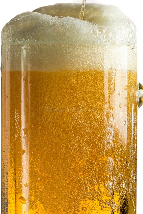 Cerveza ligera de colada en una taza de cerveza, resulta espuma y el espray foto de archivo Cerveza ligera de colada en una taza de cerveza, resulta espuma y el espray foto de archivo