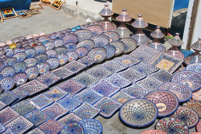 Tunisian ceramic souvenirs on display at a street market in Sidi Bou Said, Tunisia: Plates and bowls in white, blue, orange and yellow. Tunisian ceramic souvenirs on display at a street market in Sidi Bou Said, Tunisia: Plates and bowls in white, blue, orange and yellow