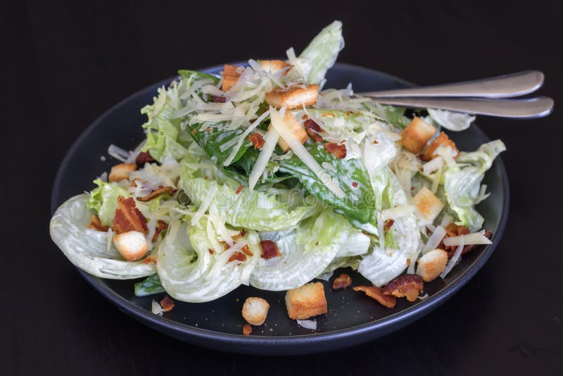 Cesar salad in black dish stock photo Cesar salad in black dish stock photo