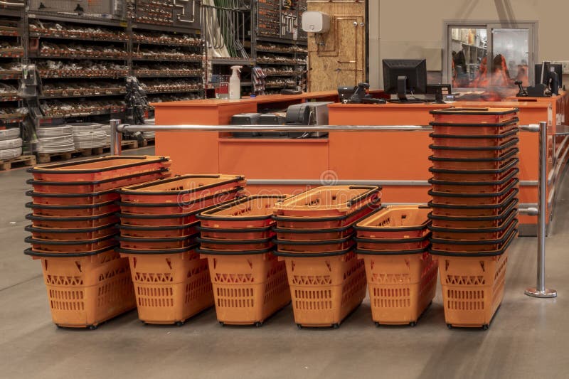 Stacked orange baskets for carrying purchases in a DIY. Stacked orange baskets for carrying purchases in a DIY