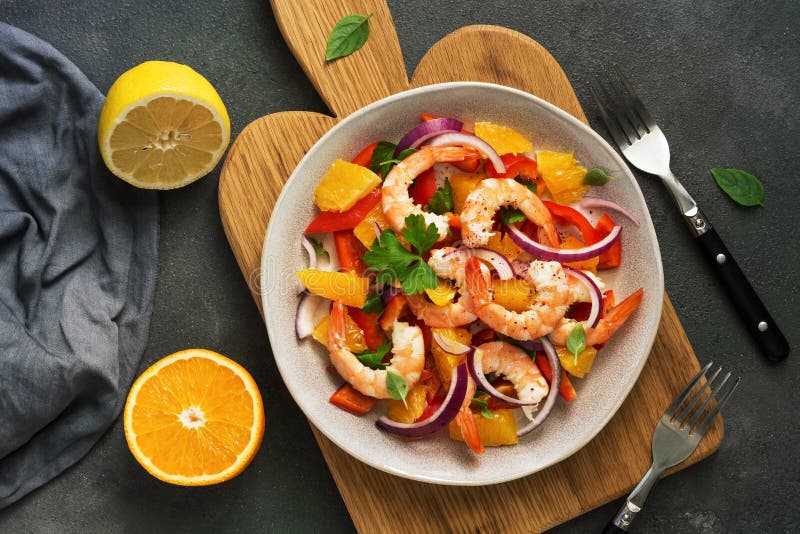 Ceviche with shrimps and orange in a plate on a cutting board. Flat lay, overhead view stock photography