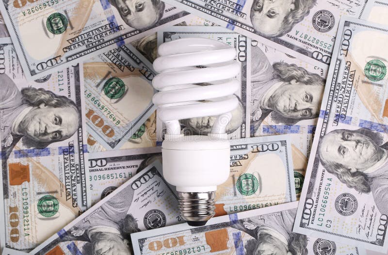 CFL Fluorescent Light Bulb on Money Dollar Cash Stock Photo Image of