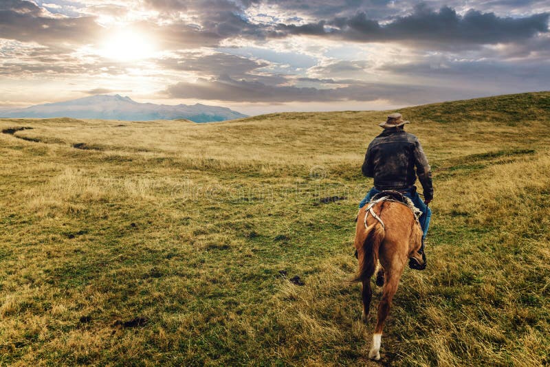 cowboys riding on the moors of Cotopaxi National Park, Equador