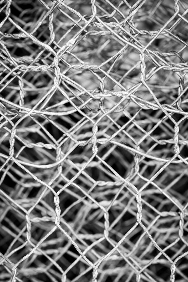 Chain link wire fence for texture background in black and white