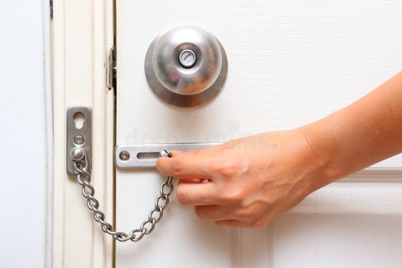 Chain lock and knob lock in door royalty free stock image