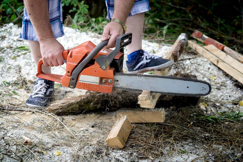 Chainsaw cutting firewood royalty free stock photo Chainsaw cutting firewood royalty free stock photo