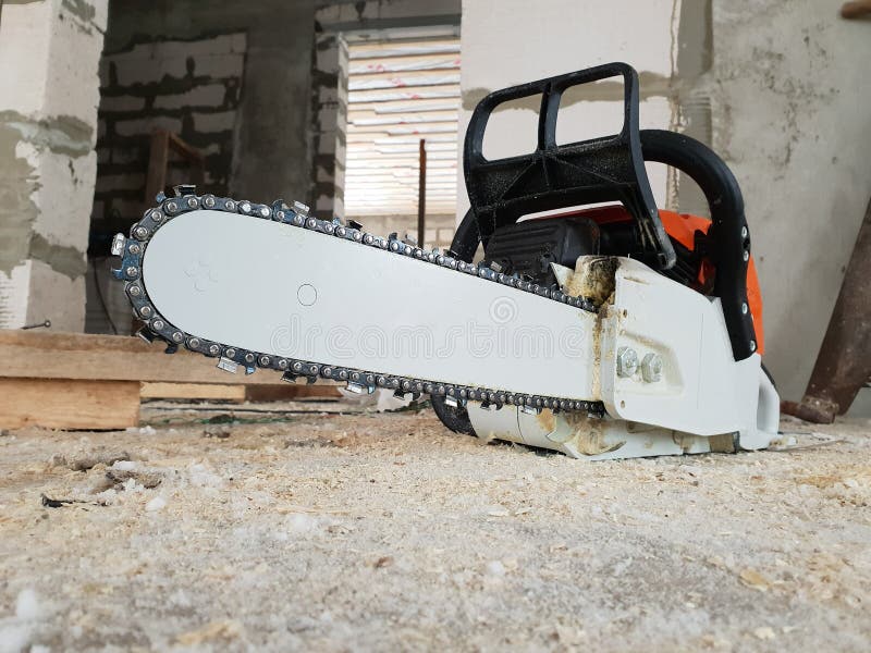 Chainsaw Is Strewn With Sawdust On The Floor In Country House
