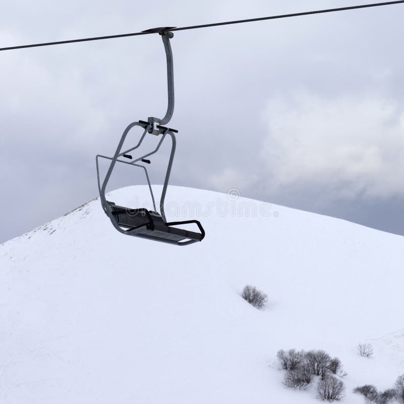 Chair lift and gray sky at evening