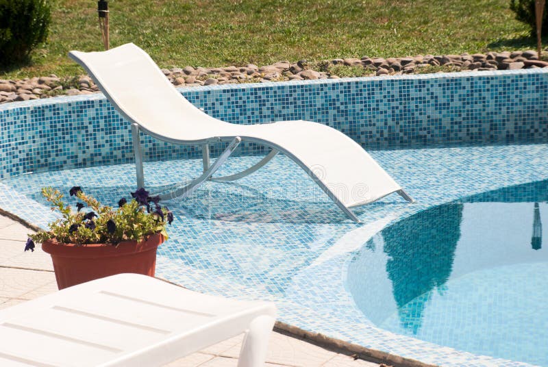 Chair near swimming pool stock image. Image of liquid 24012685