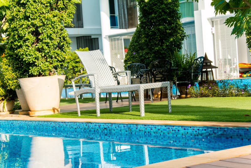 Chair near swimming pool stock photo. Image of resort 92669474