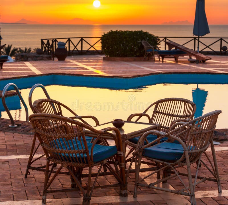 Chair near swimming pool stock photo. Image of blossom 54163938