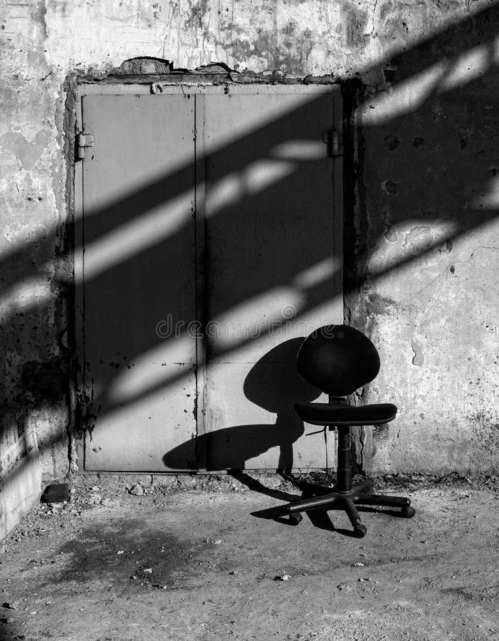 A chair and a shadow. Industrial still life.