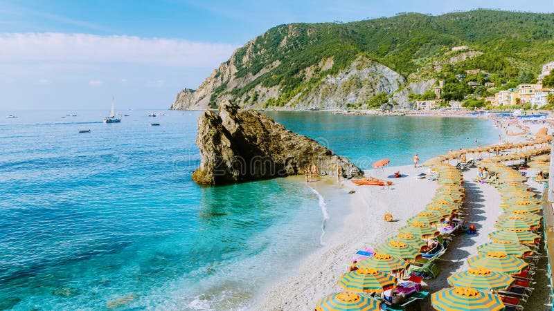 Chairs and Umbrellas Fill the Spiaggia Di Fegina Beach , the Beach ...