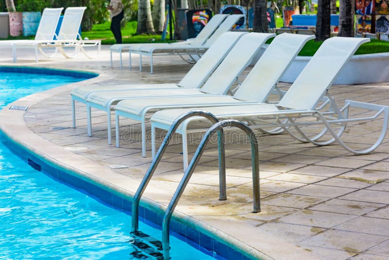Chaise lounge by the pool stock photo. Image of house 163465556