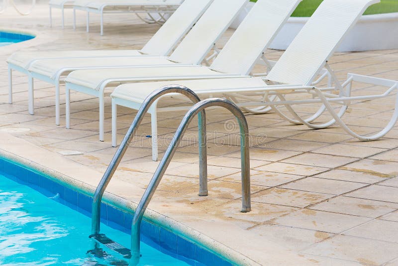 Chaise lounge by the pool stock photo. Image of relaxation 164733650