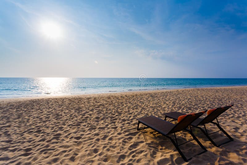 Chaise lounges on a beach stock image. Image of shore 50185701
