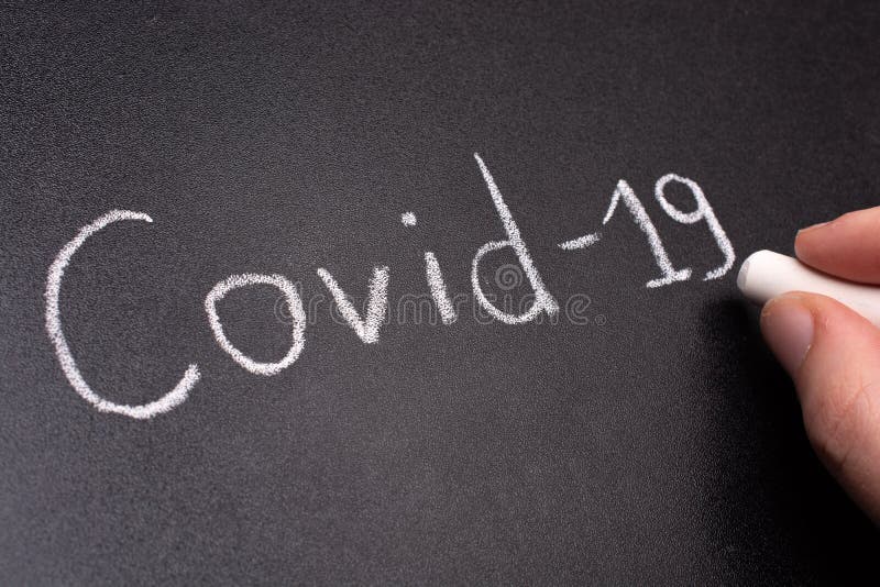 Chalk drawing of a virus COVID-19 on the background of blackboard