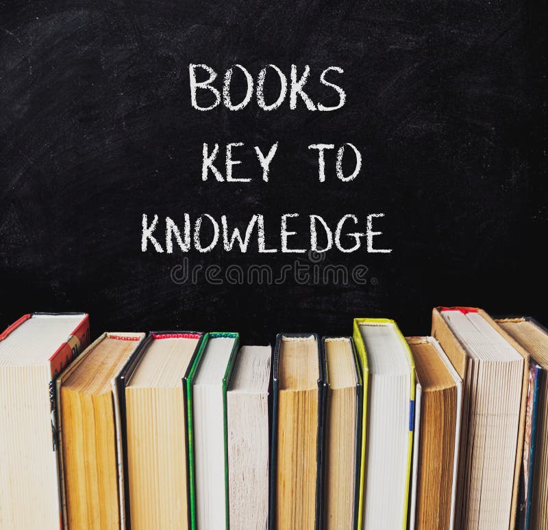 A chalkboard with a stack of books on it stock photos