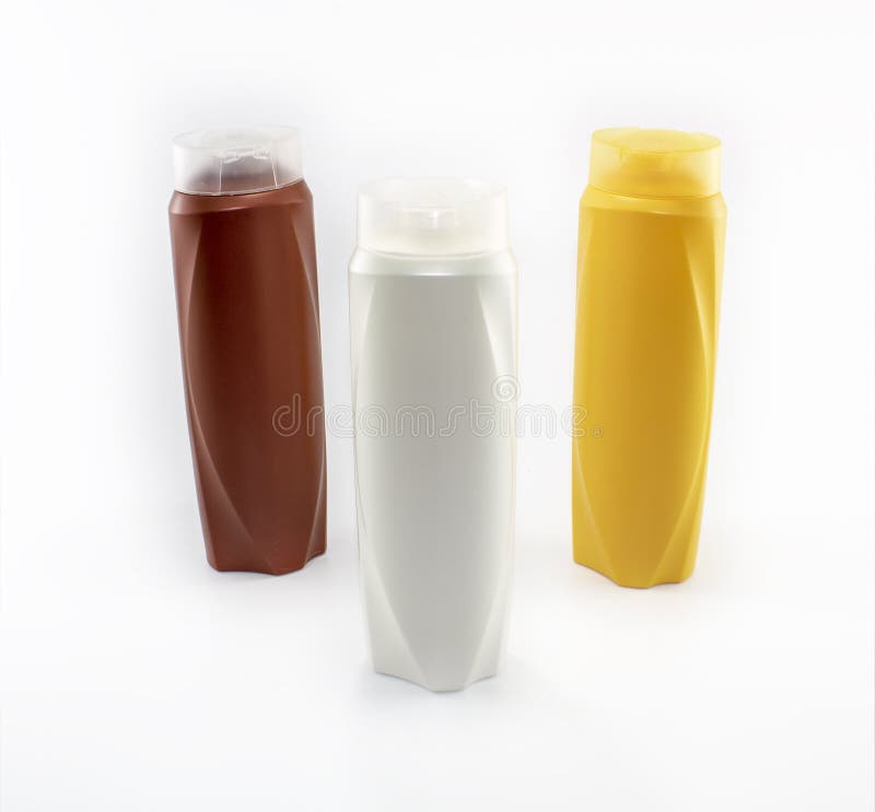 Champ?, botellas hidratantes en colores marrones, blancos, amarillos fotografía de archivo Champ?, botellas hidratantes en colores marrones, blancos, amarillos fotografía de archivo