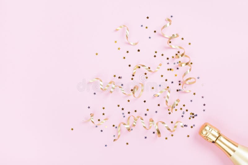 Champagne bottle with confetti stars and party streamers on pink background. Christmas, birthday or wedding concept. Flat lay. royalty free stock photo Champagne bottle with confetti stars and party streamers on pink background. Christmas, birthday or wedding concept. Flat lay. royalty free stock photo