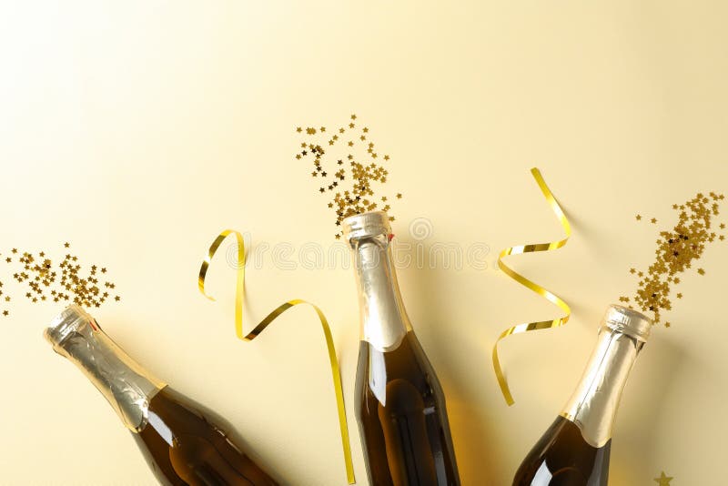 Champagne Bottles and Glitter on Beige Background Stock Photo - Image ...