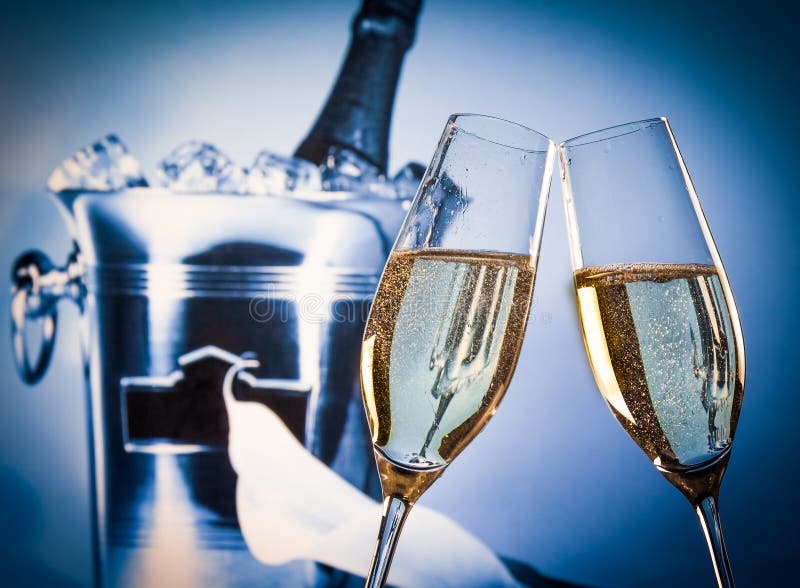 Champagne flutes with golden bubbles in front of champagne bottle in bucket stock photos Champagne flutes with golden bubbles in front of champagne bottle in bucket stock photos