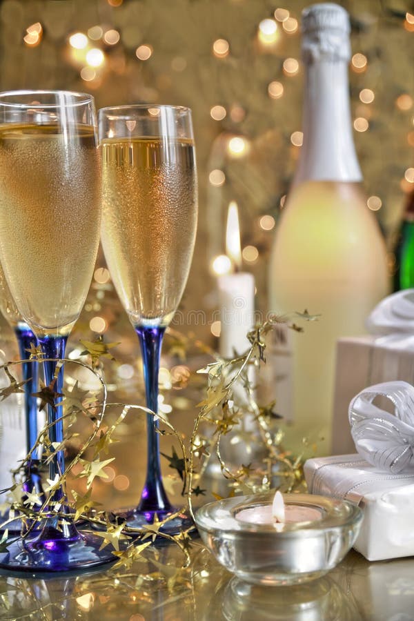 Champagne in glasses, gift box and lights