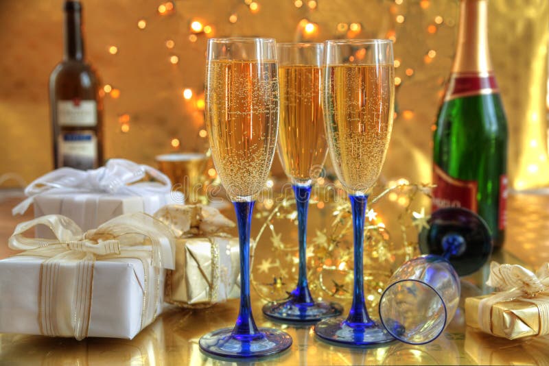 Champagne in glasses and gift boxes.