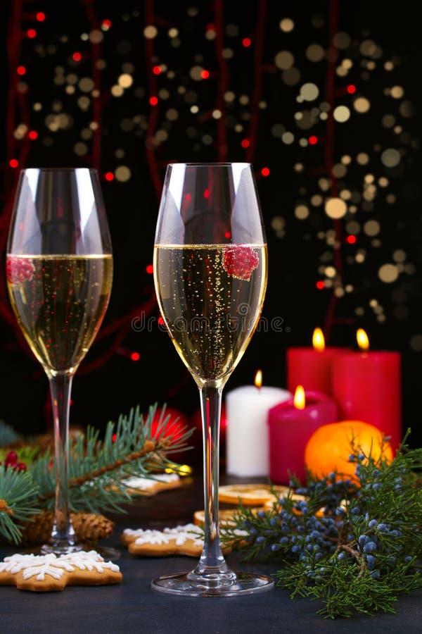 Champagne glasses in holiday setting. Christmas and New Year celebration with champagne. Christmas holiday decorated table with wh