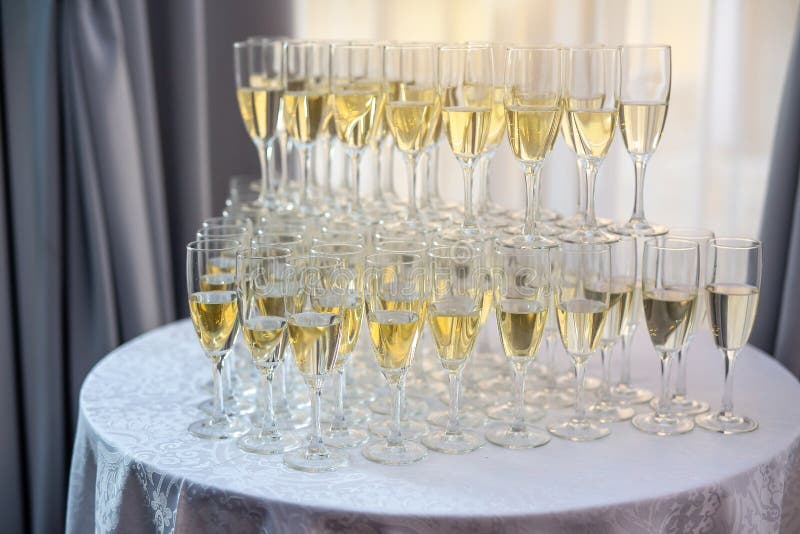 Champagne Glasses Standing on Round Table at the Party Stock Photo