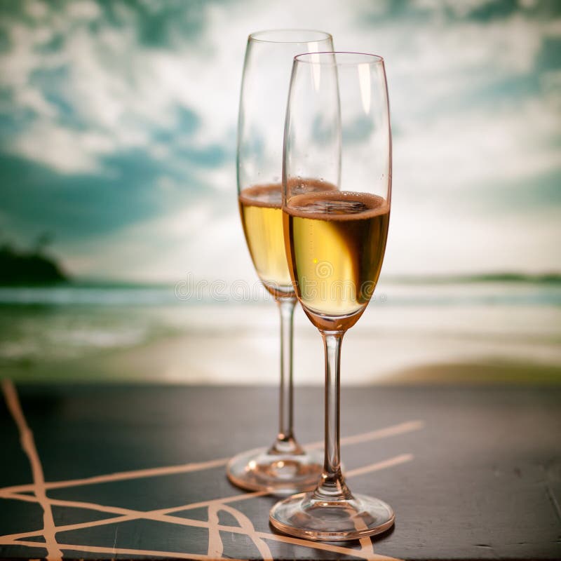 Champagne glasses on tropical beach - exotic New Year