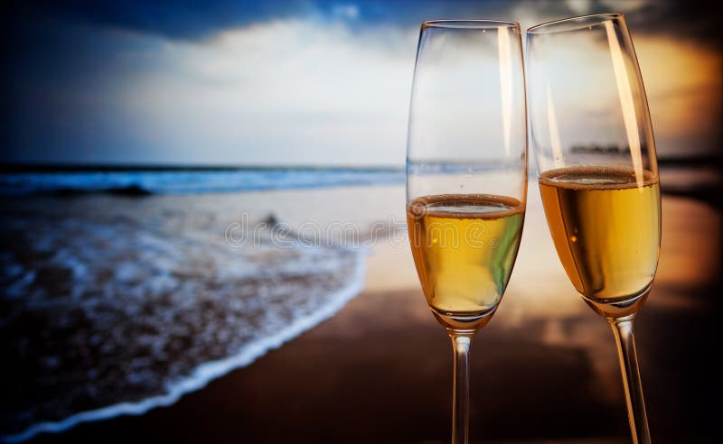 Champagne glasses on tropical beach - exotic New Year