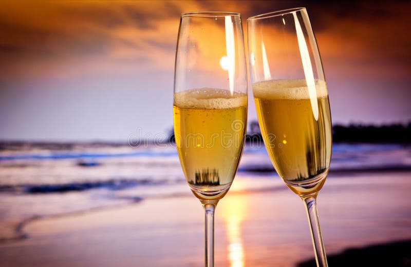 Champagne glasses on tropical beach - exotic New Year