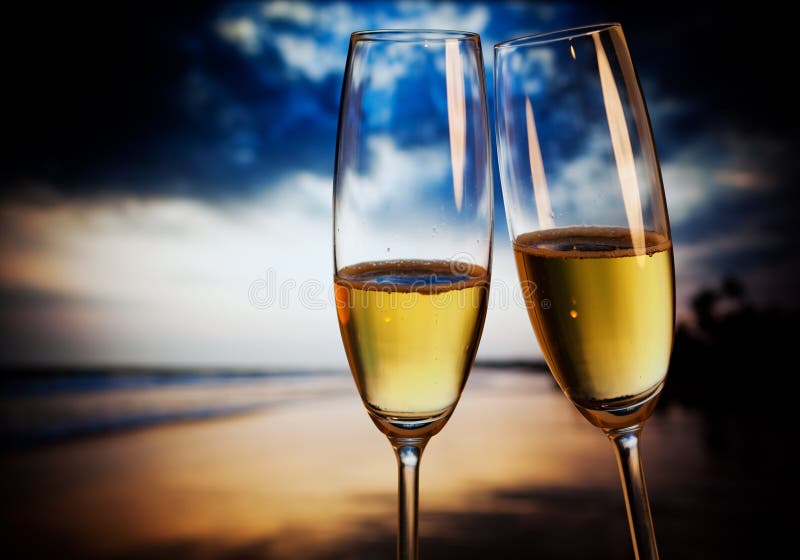 Champagne glasses on tropical beach - exotic New Year