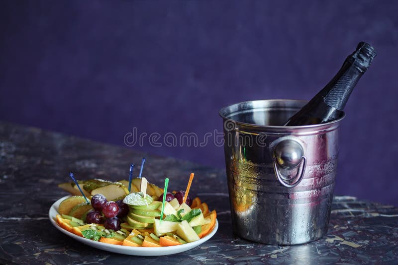 Champagne in a Hotel Room, Ice Bucket, Glasses and Fruits on a Plate stock images Champagne in a Hotel Room, Ice Bucket, Glasses and Fruits on a Plate stock images