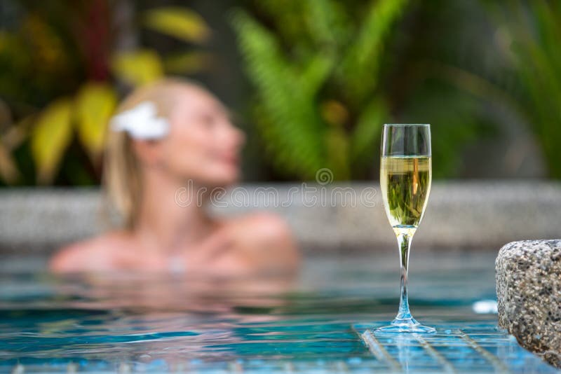 Champagne near swimming pool on a background of a beautiful woman