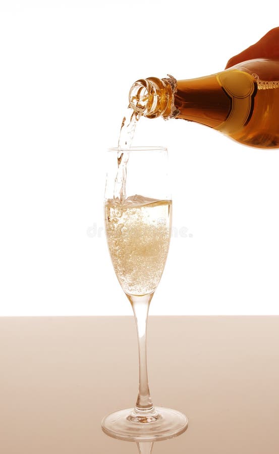 Champagne pouring into elegant glass stock image