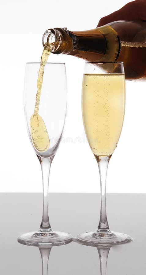 Champagne pouring into elegant glass royalty free stock photography