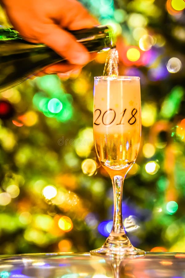 Champagne or wine 2018 glass on sparkling background
