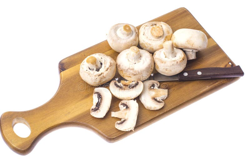 Champignons på kökträskärbräda fotografering för bildbyråer Champignons på kökträskärbräda fotografering för bildbyråer