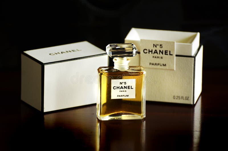 The iconic and famous French Chanel No 5 parfum perfume was created by the Parisian fashion businesswoman Mademoiselle Coco Chanel in 1921 in Paris, France. Yet still today the fragrance continues to be the worlds top and best selling scent in fame, style and sales with reports of one bottle sold every 30 seconds. Coco also changed the face of advertising with this perfume by choosing to do it herself and be photographed as the wearing of the scent and then continued to be first at using famous celebrities in her advertising such as the and beautiful Marilyn Monroe. This is a photograph of the iconic and beautiful glass bottle with the diamond stopper and the simple but elegant black and white box, Coco Chanel was renowned for. The image is isolated on a dark black background. The iconic and famous French Chanel No 5 parfum perfume was created by the Parisian fashion businesswoman Mademoiselle Coco Chanel in 1921 in Paris, France. Yet still today the fragrance continues to be the worlds top and best selling scent in fame, style and sales with reports of one bottle sold every 30 seconds. Coco also changed the face of advertising with this perfume by choosing to do it herself and be photographed as the wearing of the scent and then continued to be first at using famous celebrities in her advertising such as the and beautiful Marilyn Monroe. This is a photograph of the iconic and beautiful glass bottle with the diamond stopper and the simple but elegant black and white box, Coco Chanel was renowned for. The image is isolated on a dark black background.