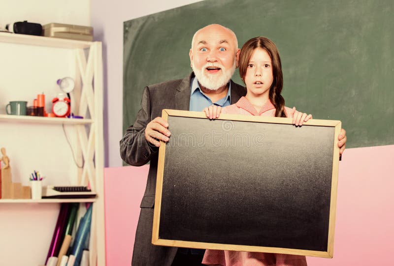 Change Is Here. blackboard for information and announcement. Copy space. small girl with man tutor study. empty chalk stock images Change Is Here. blackboard for information and announcement. Copy space. small girl with man tutor study. empty chalk stock images