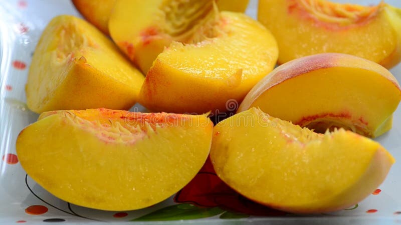 Changing the focus point with a plate of ripe sliced peach, soft focus